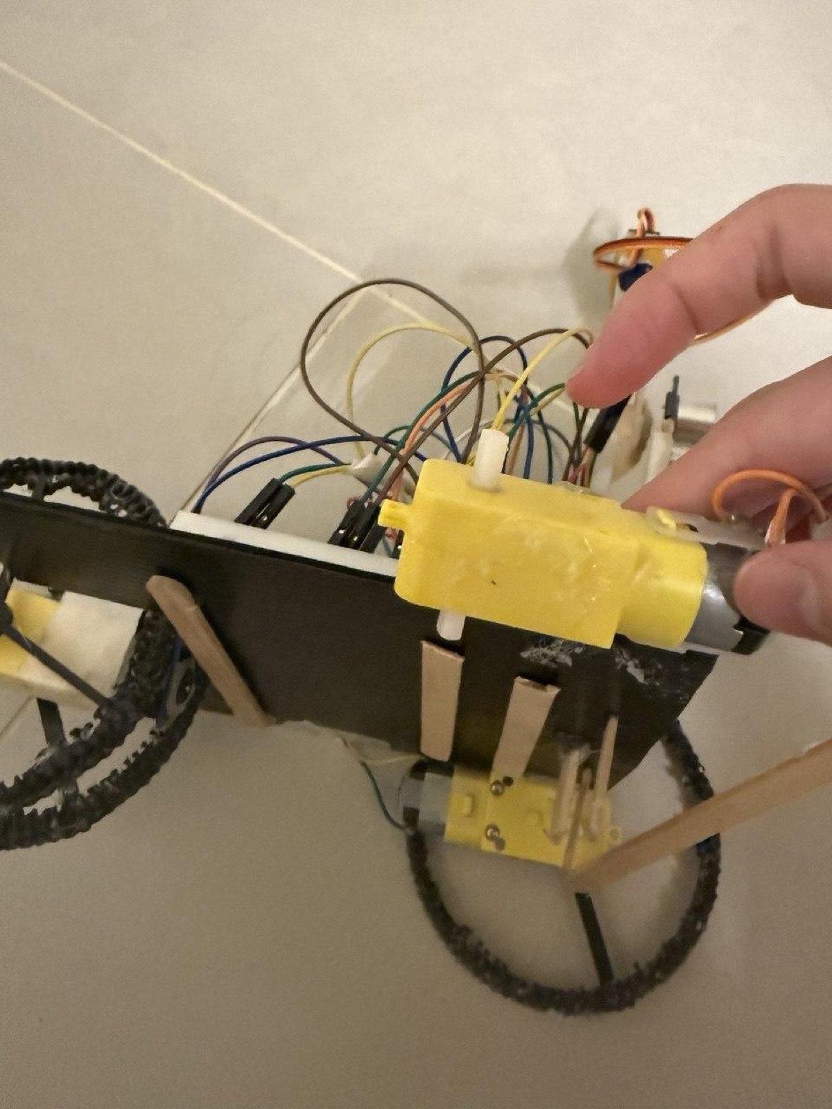 The robot with one motor removed, being held for readjustment