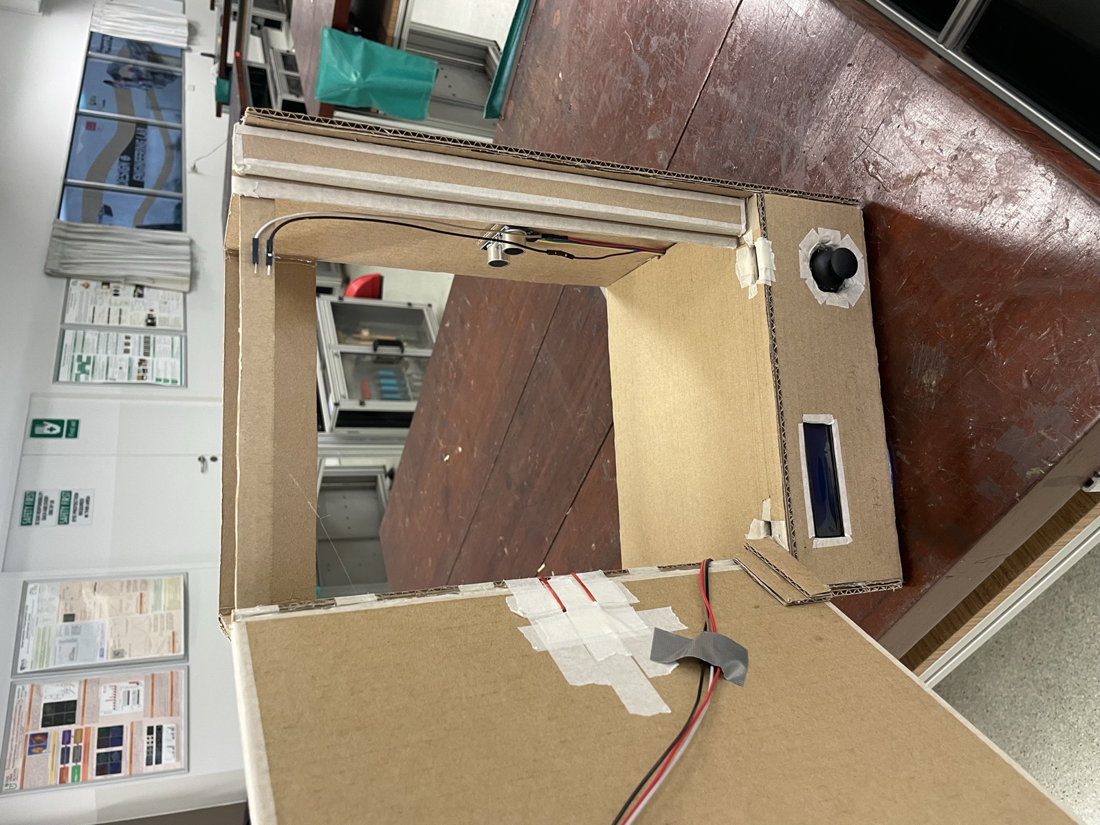 The gate with its door swung open, showing the sensors on the inside of the frame