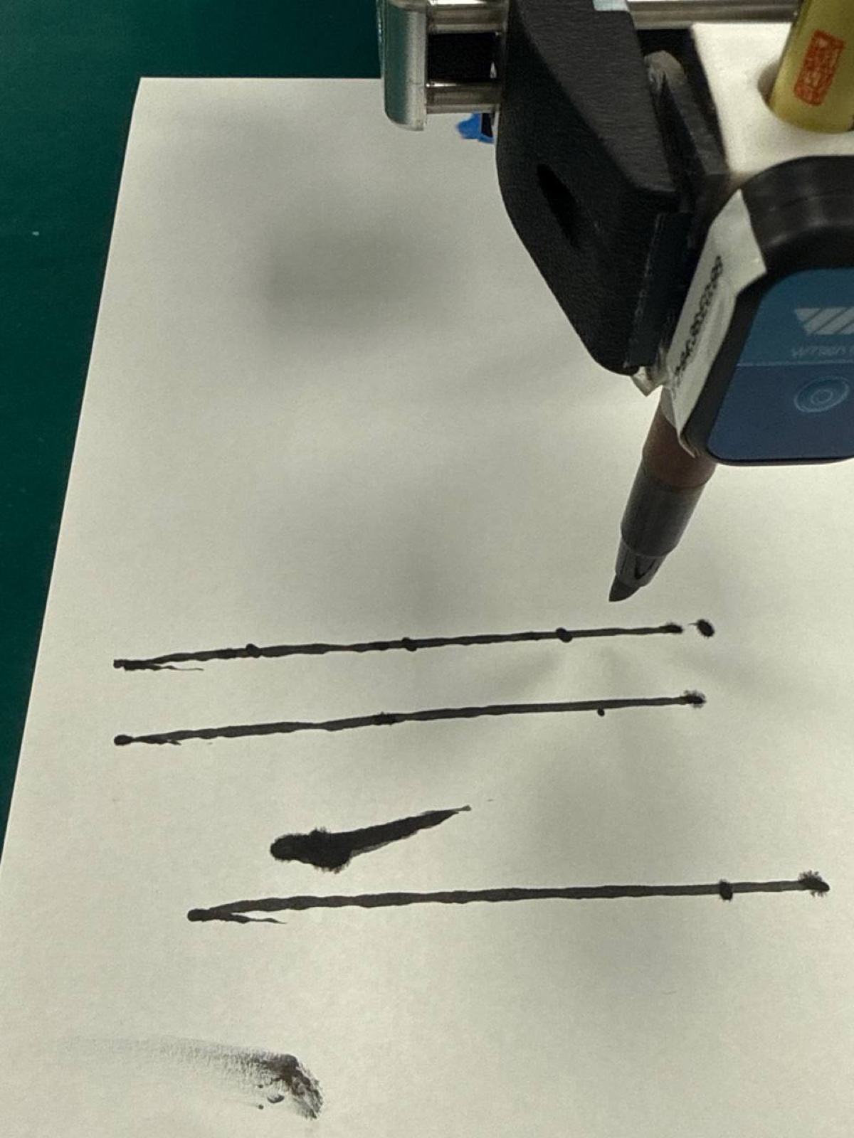 The arm marking dots along a previously drawn line